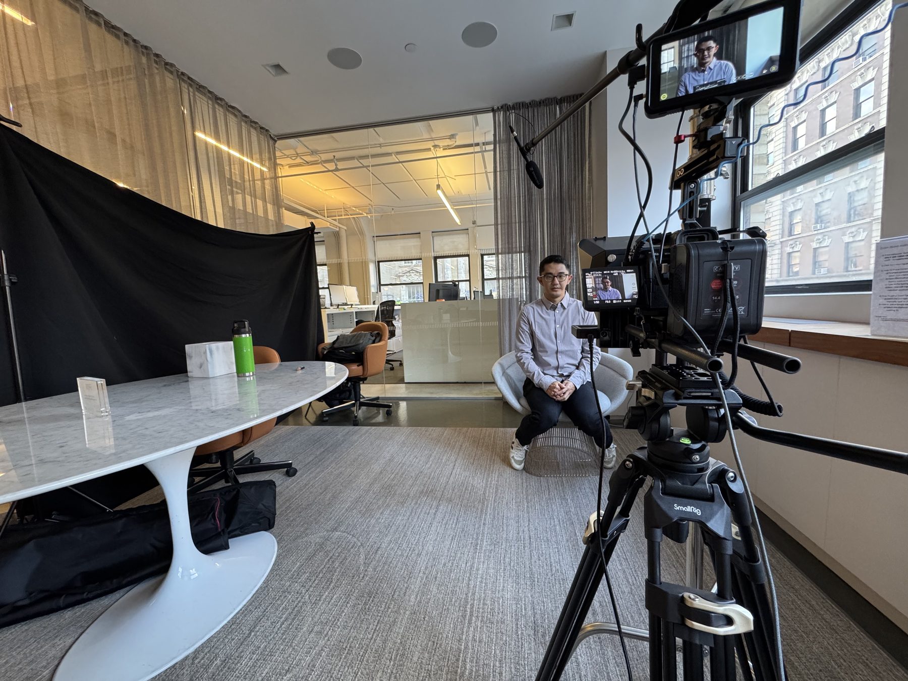 A cinema camera rig set up for an interview in a New York office